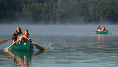People canoeing on a lake.