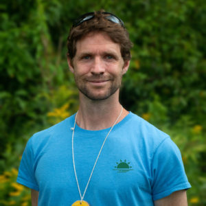 Headshot of Stuart smiling and wearing a blue Horizons t-shirt.