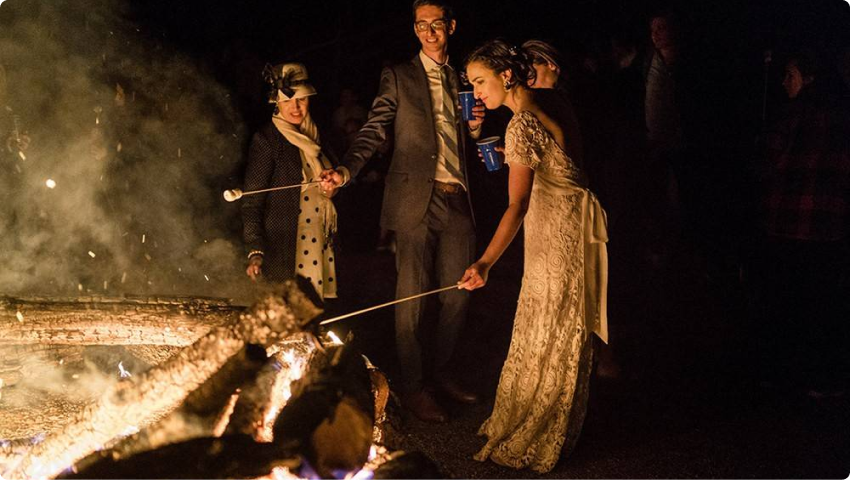 Roasting marshmallows over a fire.