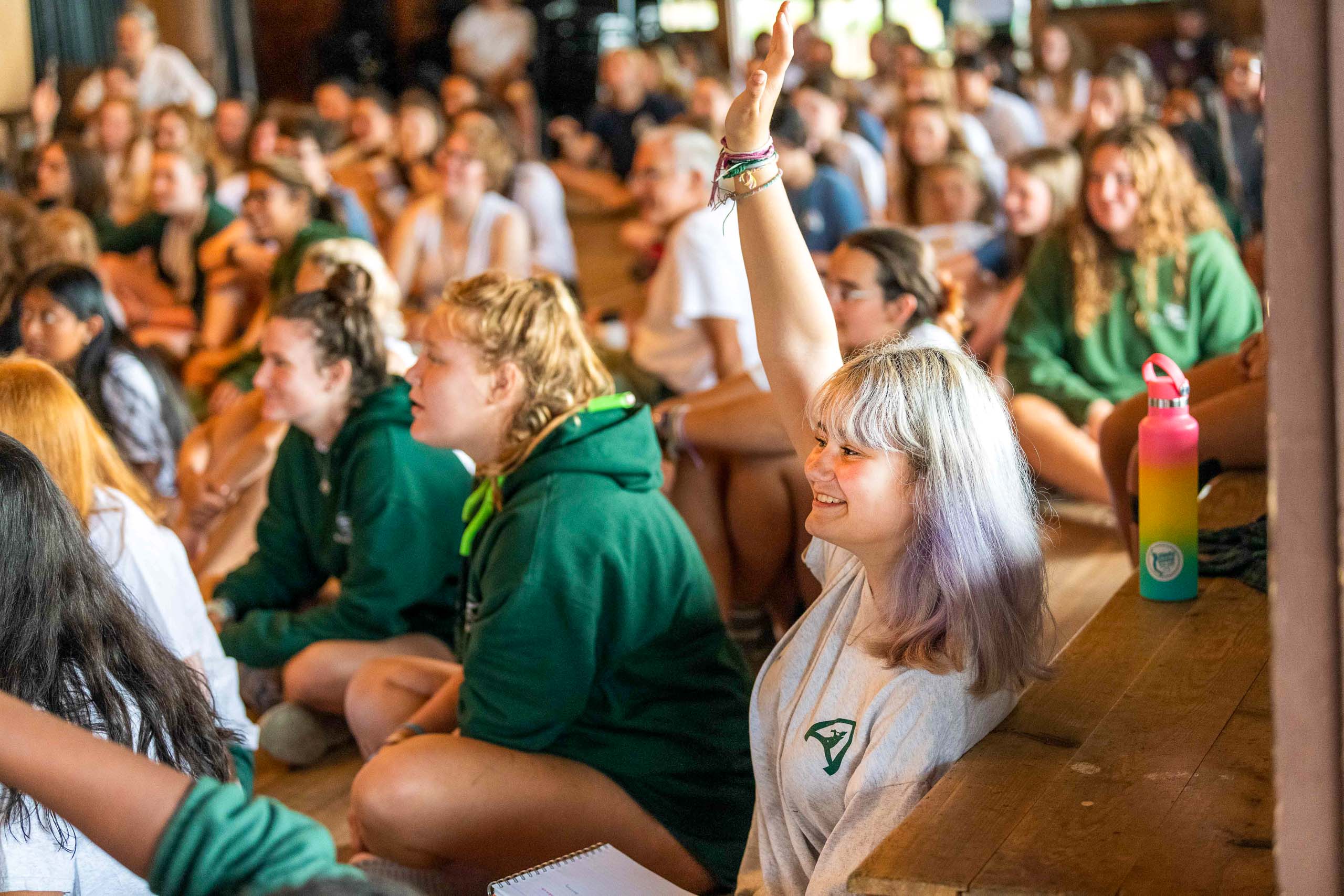Campers raising hands.