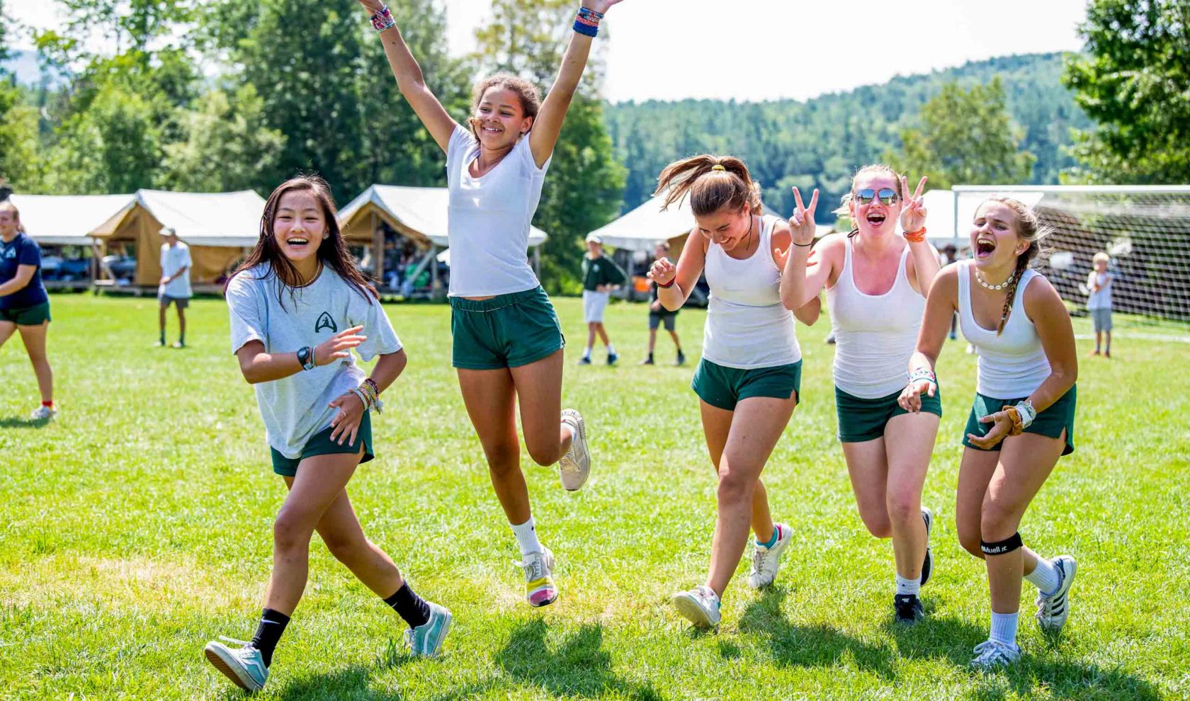 A group of Aloha campers running and laughing.