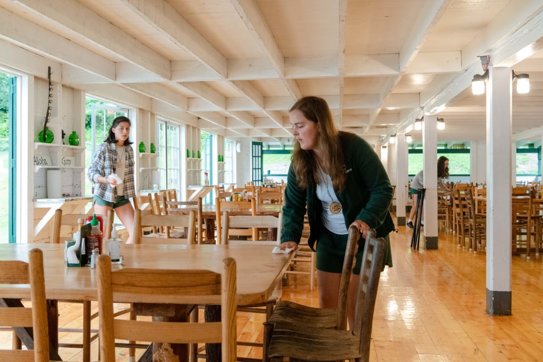 Staff cleaning the dining tables.