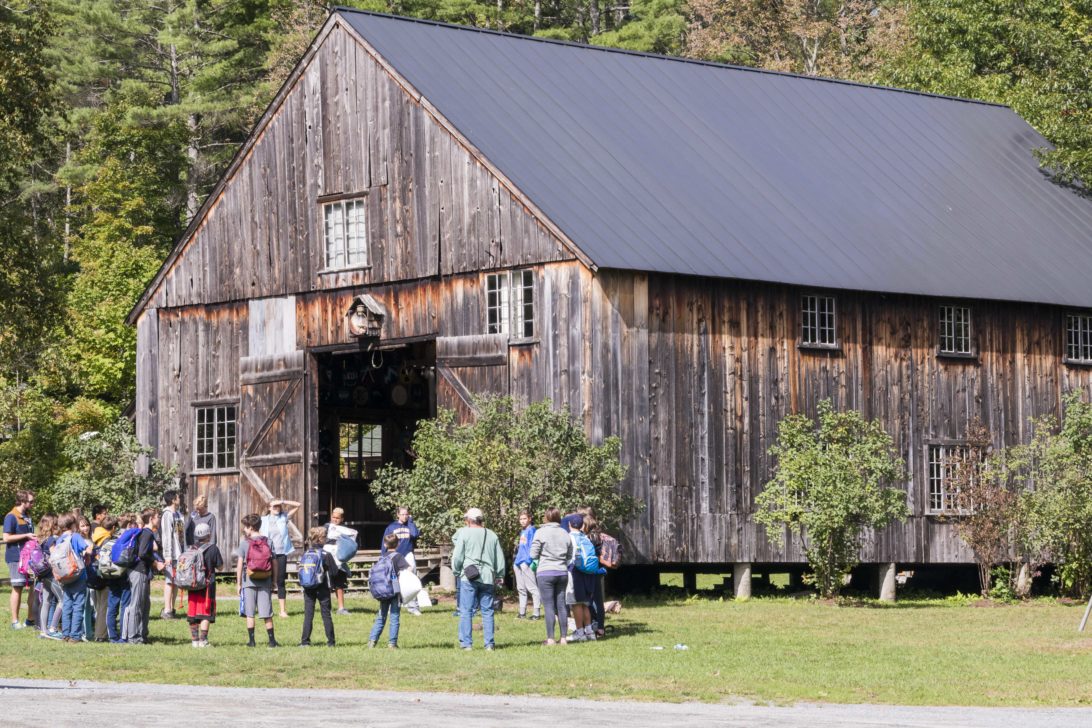 A Hulbert school group in a circle in front of the barn.
