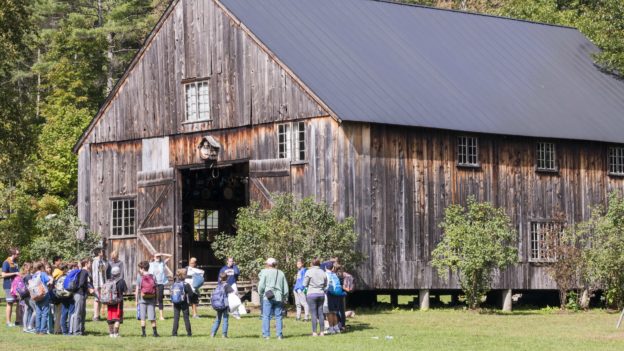 A Hulbert school group in a circle in front of the barn.