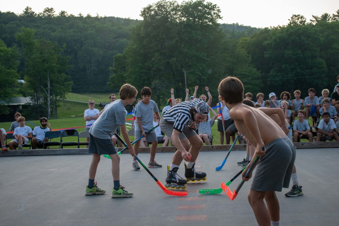 Campers playing street hockey.