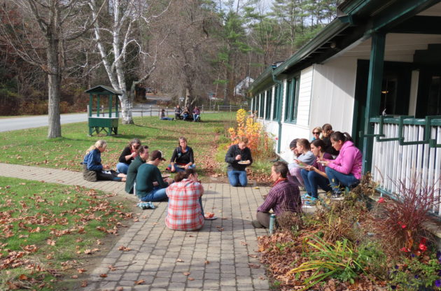 A group of people sitting together in a circle.