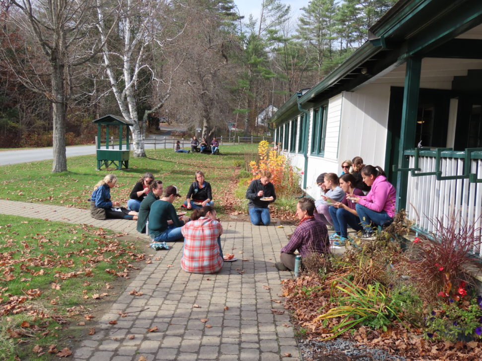 A group of people sitting together in a circle.