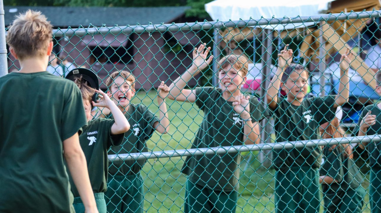 Lanakila campers watching a baseball game.