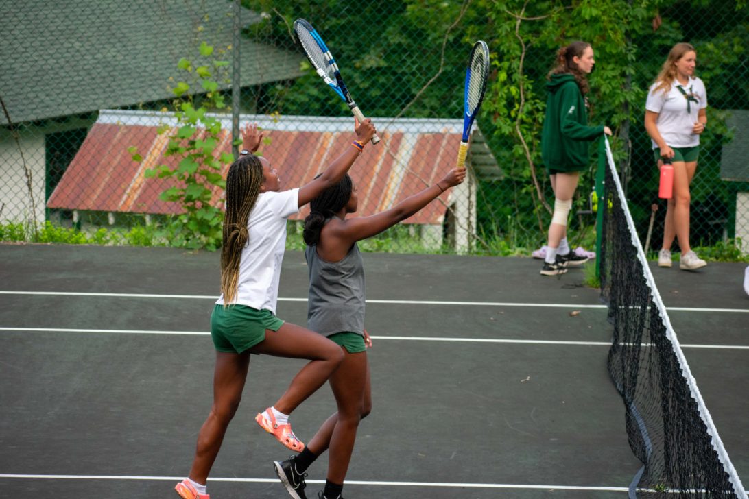 Aloha campers playing tennis.