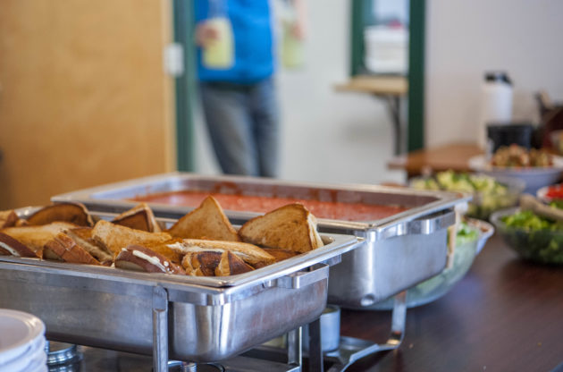 A buffet line with grilled cheese sandwiches.