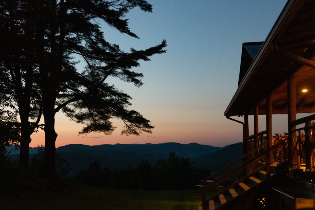 A sunset with a lodge in the foreground.