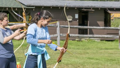 A child learning to shoot arrows at Hulbert.