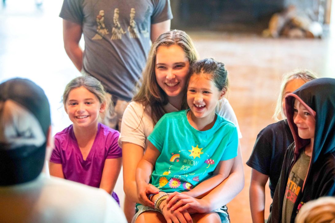 Campers smiling and laughing listening to a story Horizons.
