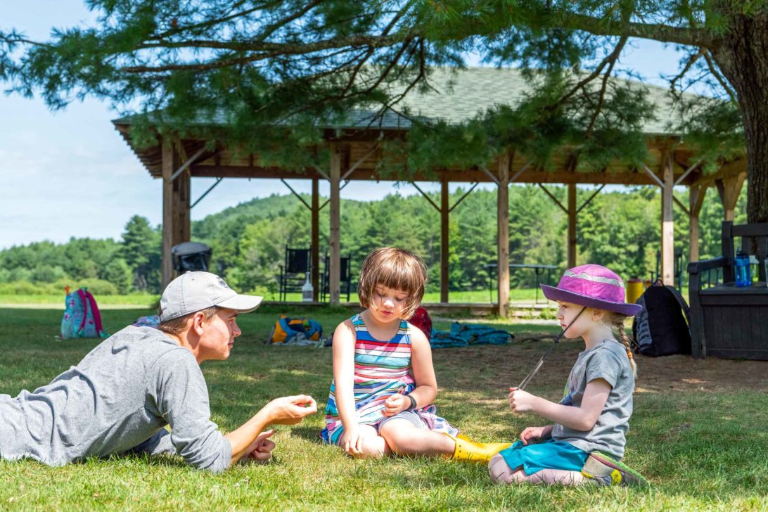 Counselor talking to campers in the field at Horizons.