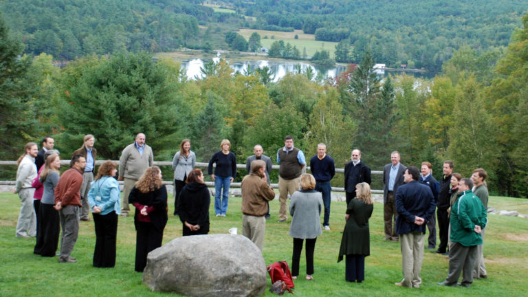 A group of of people standing in a circle.
