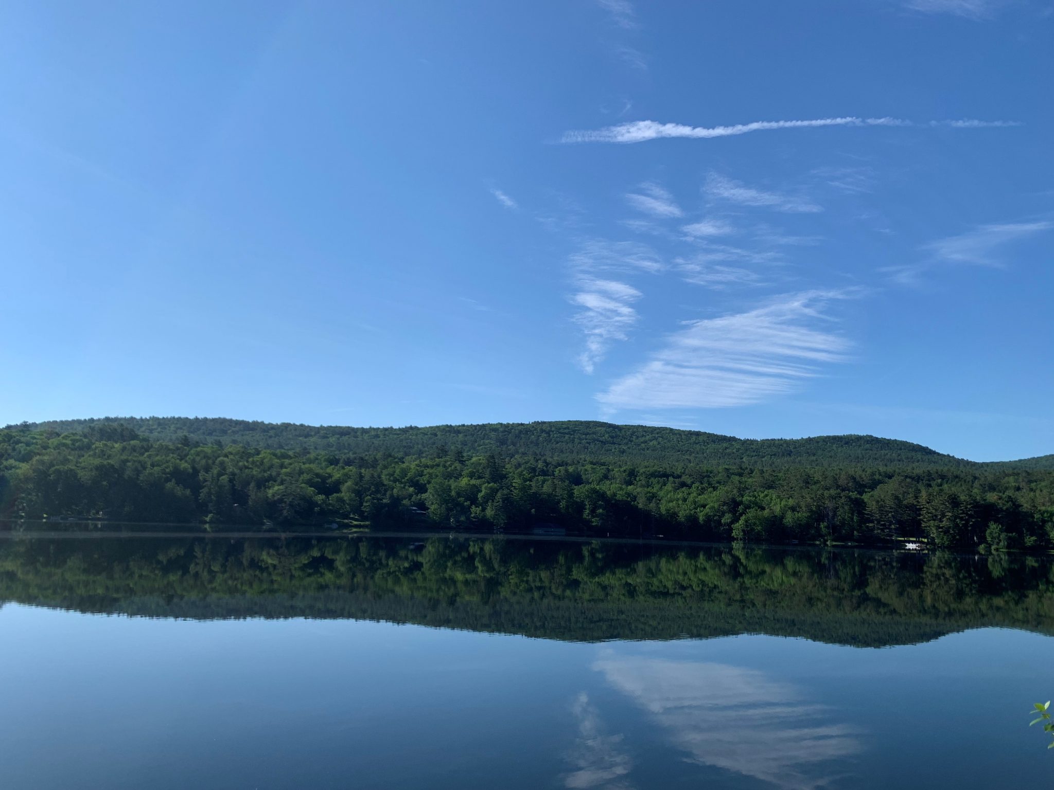 A landscape of the lake and blue mountains.