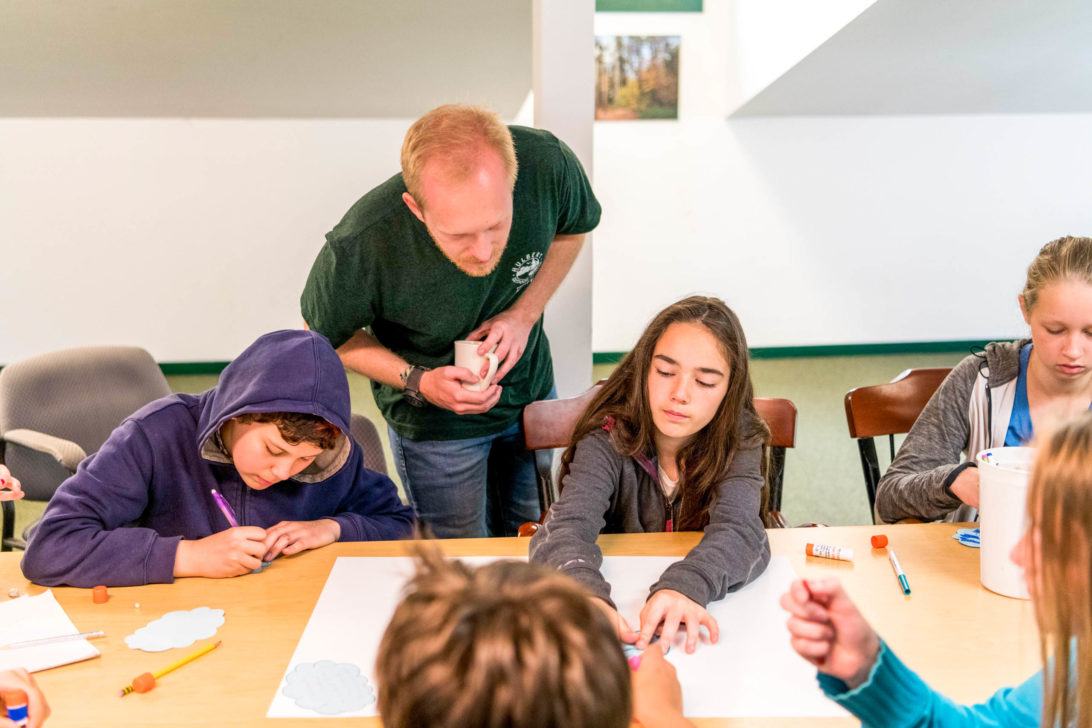 A Hulbert instructor watching students drawing.